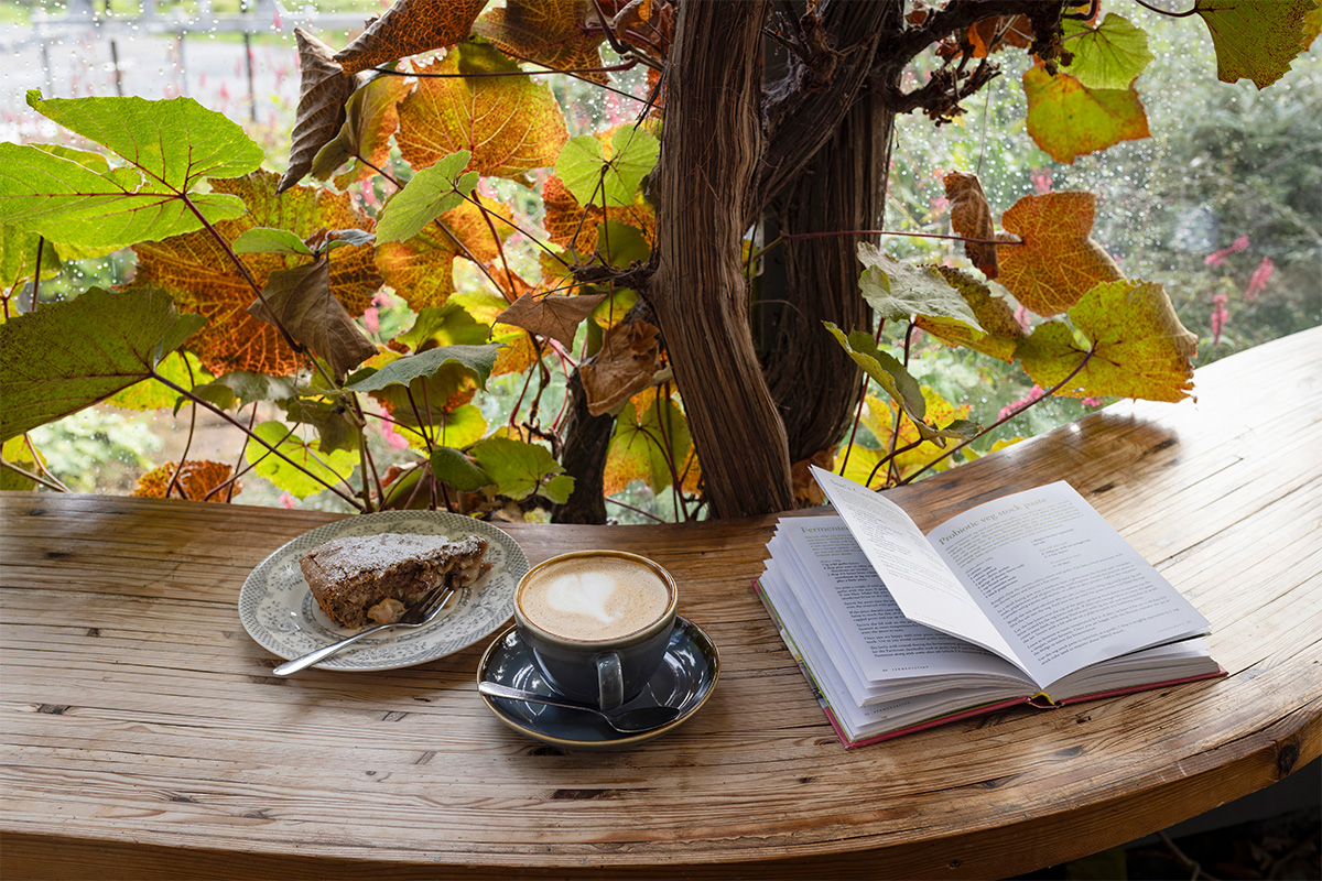 Coffee, book and cake on table