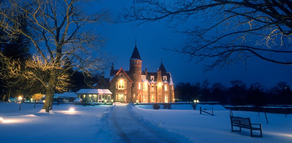 A grand hotel with grounds covered in snow