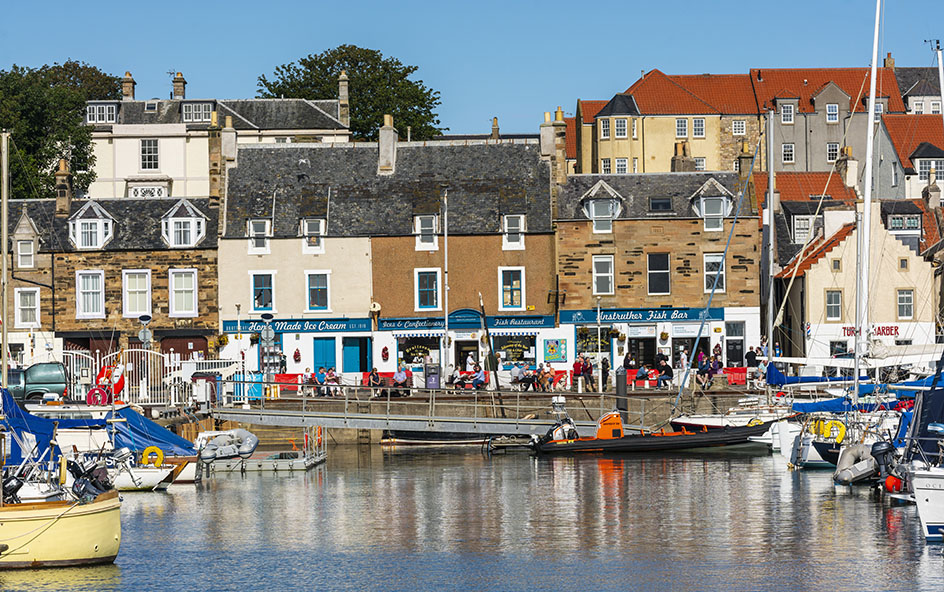 A harbour with boats and buildings in the background