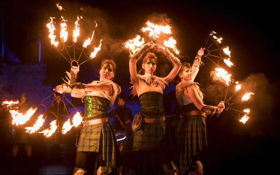 A group of woman holding fire torches