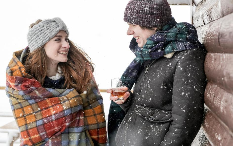 A wide beach with a cliff in the background