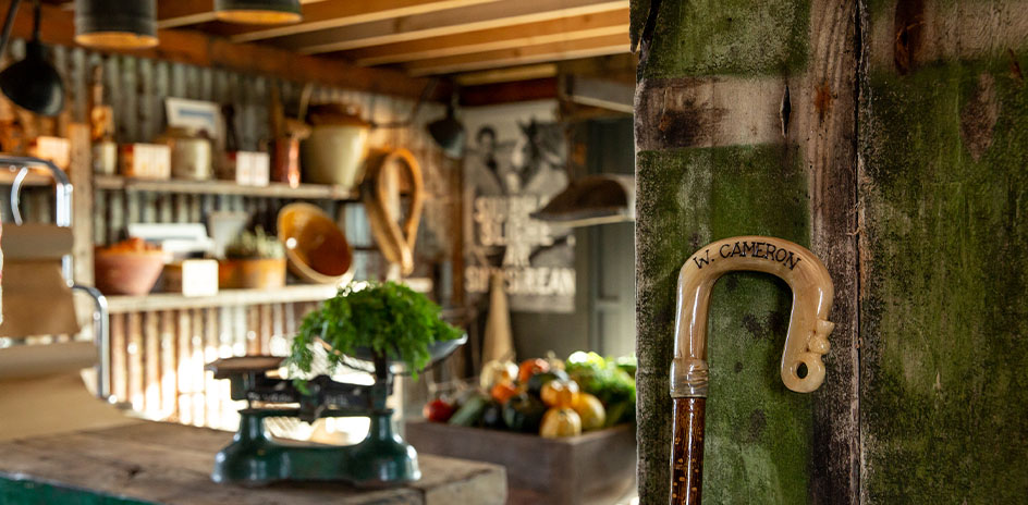 interior of a farm shop with a walking stick and fresh vegetables on display