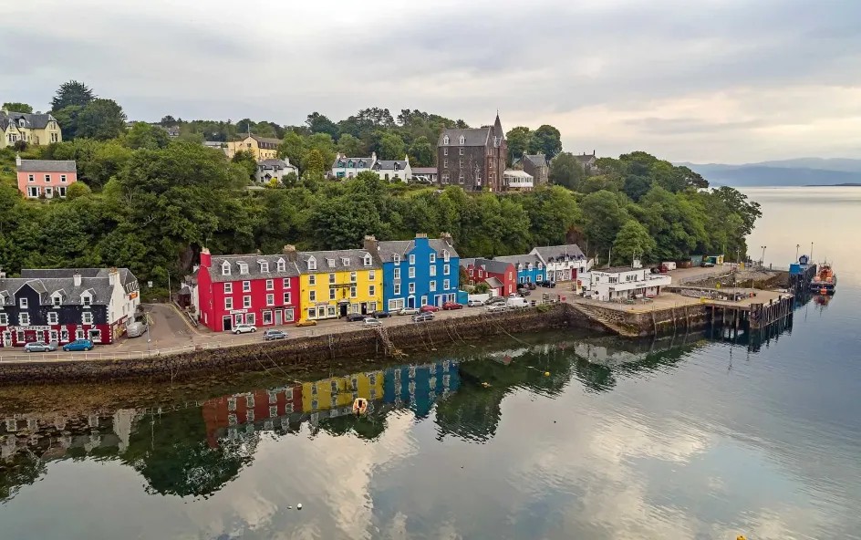 Row of colourful houses beside the harbour and sea.