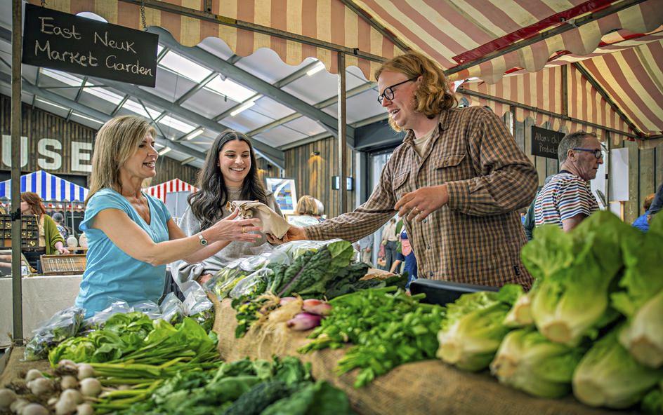 Produce being bought at farmers market