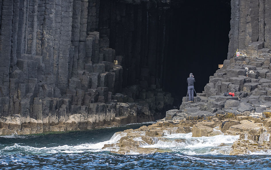 A photographer at Fingal's Cave