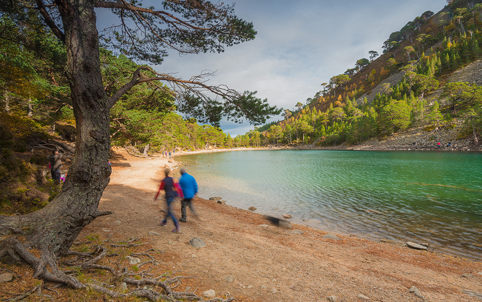 Couple walking beside loch setting