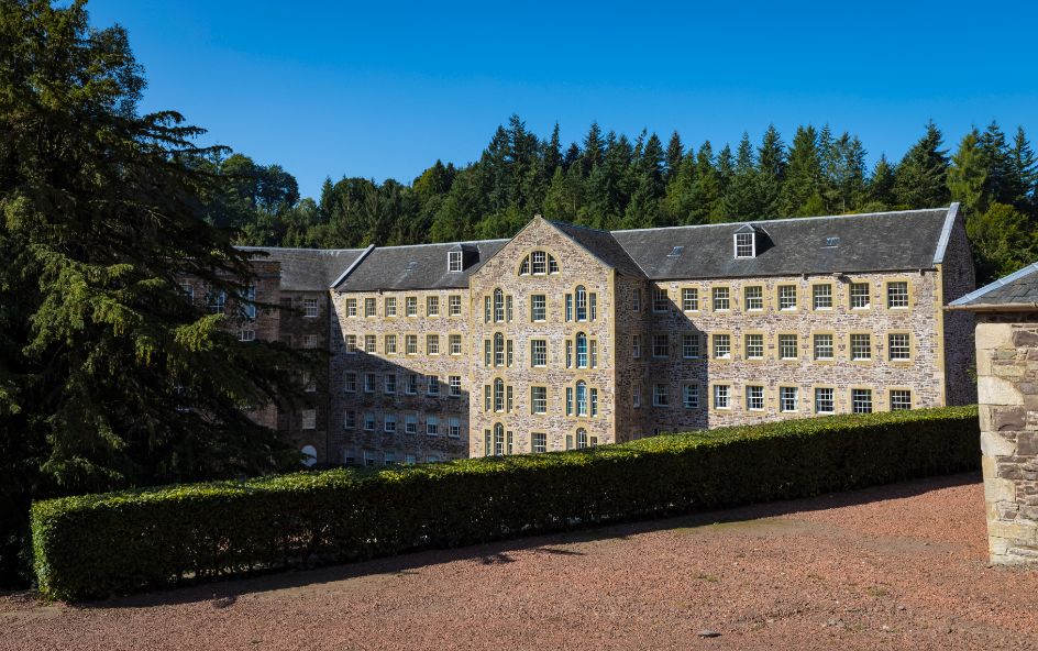 A large building with a hedge in front of it