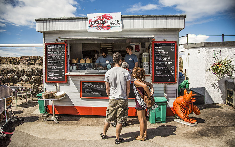People standing in front of a food truck
