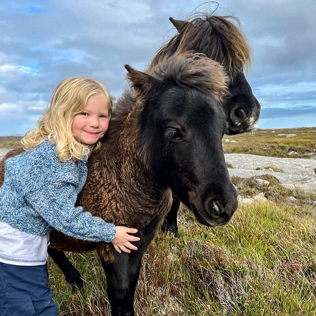 Child with ponies at Long Island Retreats, South Uist