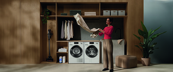 Woman holding laundry that just came out of Miele tumble dryer