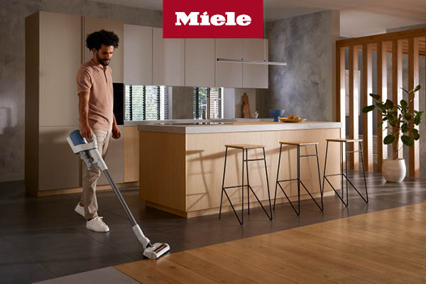 Man vacuum kitchen floor using Duoflex vacuum cleaner 