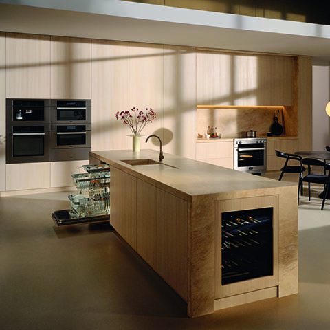 A kitchen featuring a Miele under counter wine unit, dishwasher, built-in coffee machine, range, and multiple ovens