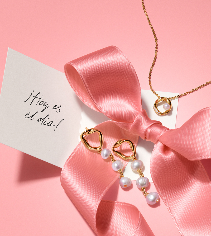 14k gold plated earrings with pearls and matching necklace sitting on a pink bow with a note that says 