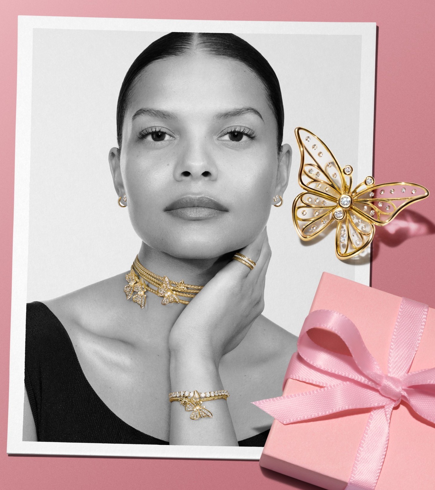 Close up on a smiling woman's face as she shouts, styled in stacked gold-plated MOM rings. 