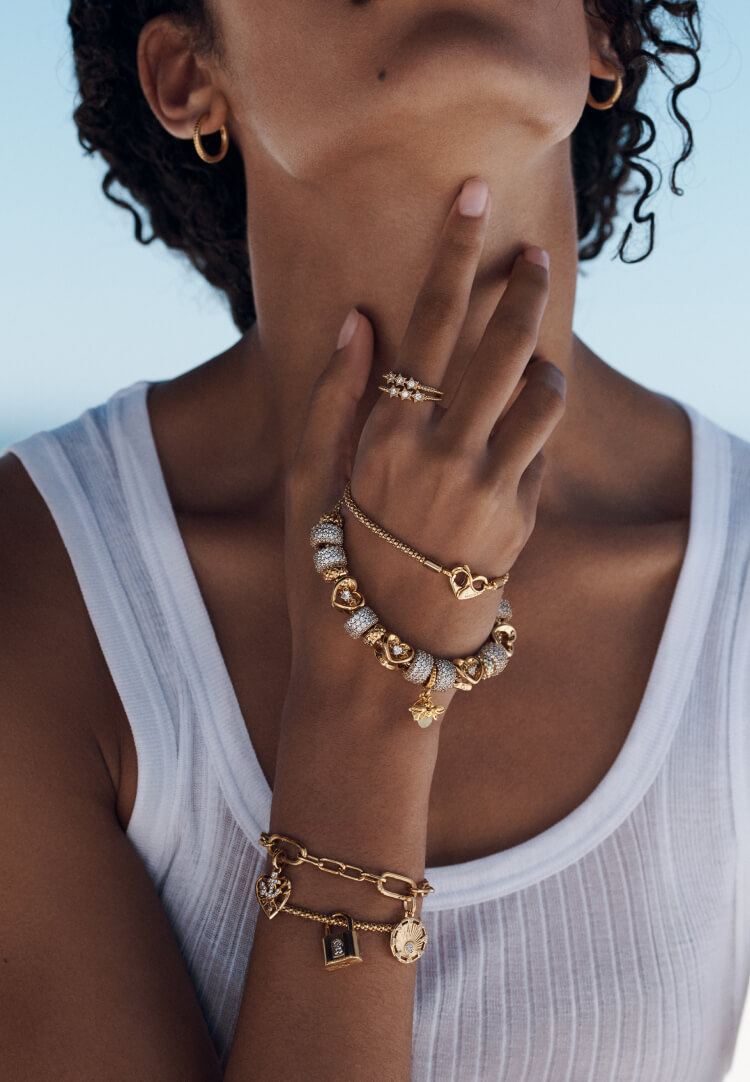 Model wears Pandora bracelets with charms