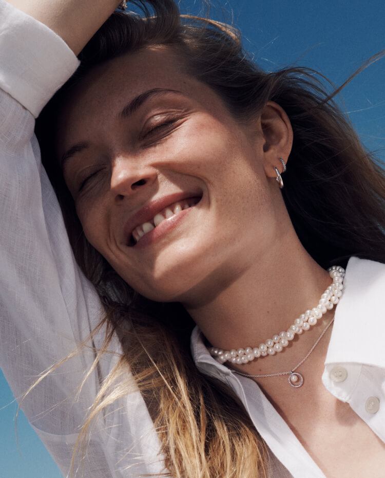 Smiling model in Pandora necklaces