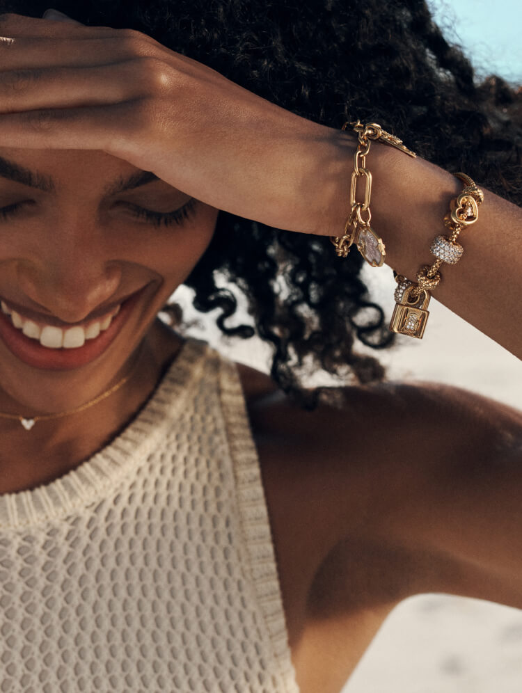 Model wears Pandora bracelets with charms