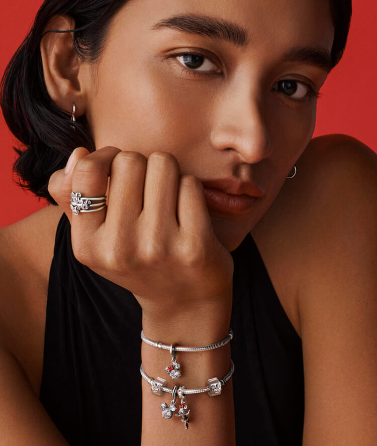 Model wears Pandora bracelet with Disney x Pandora