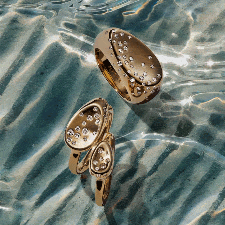 A model poses in 14k gold-plated Pandora jewellery.