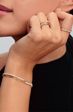 Close up of bracelets, rings and earrings with contrasting metals and textures