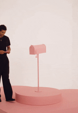 Man placing Pandora gift in mailbox