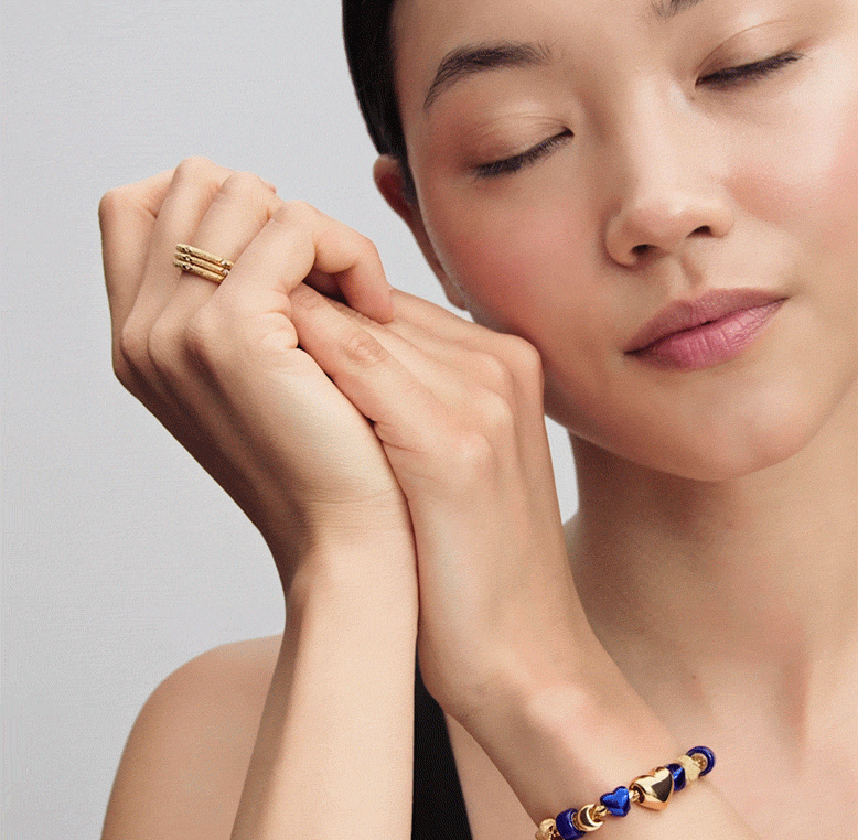 Model wears a bracelet featuring blue and gold minis