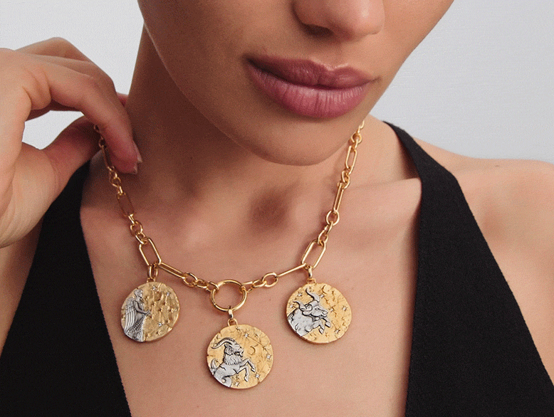 Model wears a trio of Pandora Talisman zodiac medallions.