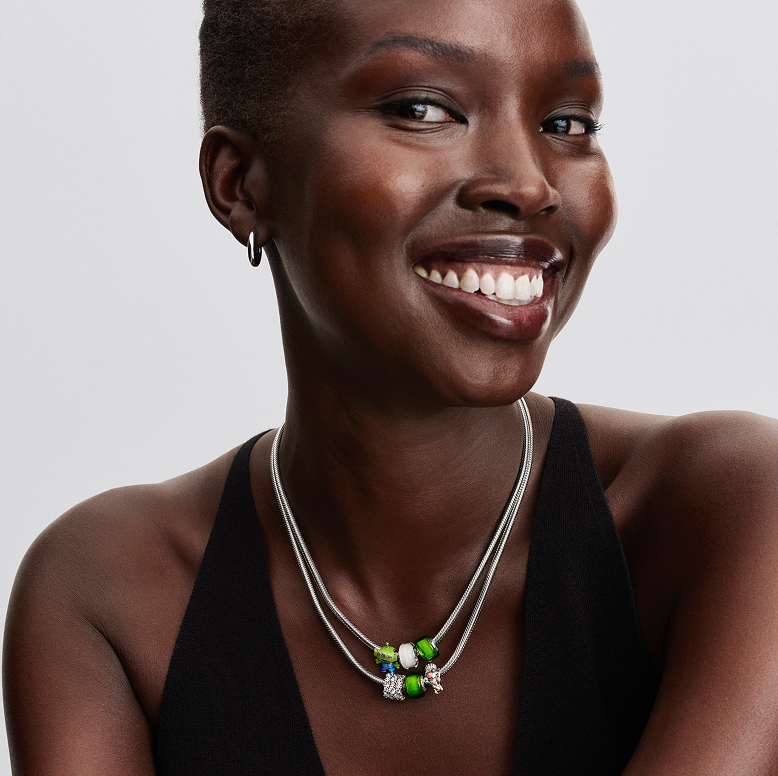 Model wearing necklace with charms