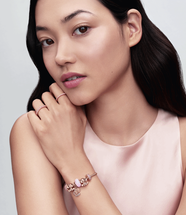 Model wearing Pandora 14k rose-gold plated charm bracelet