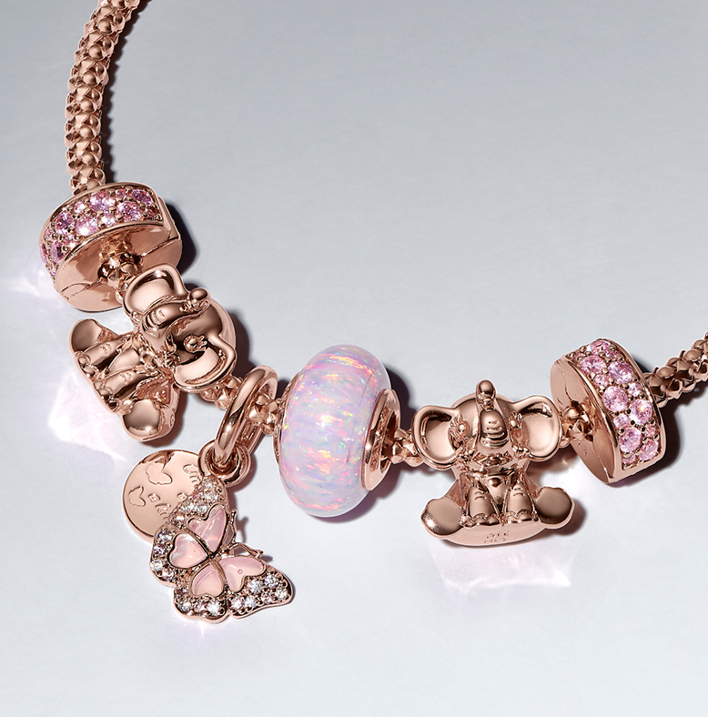 Woven bracelet with mix of charms in 14k rose gold plating