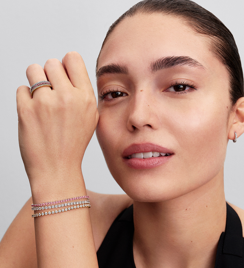 Model wearing Pandora Timeless stacked sparkling band rings and tennis bracelets