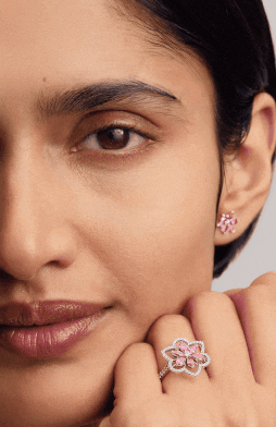 Cherry blossom sterling silver rings and earrings on surface