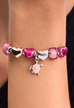 A tonal pink styling, featuring the turtle charm