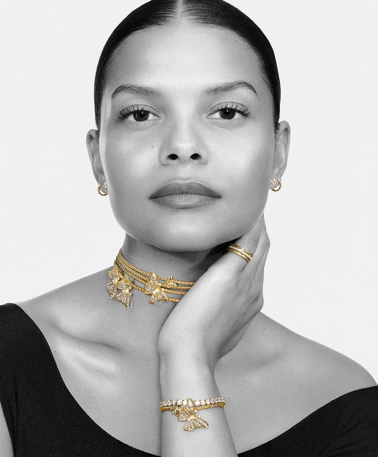 Model wearing Pandora butterfly charms on necklaces and bracelet