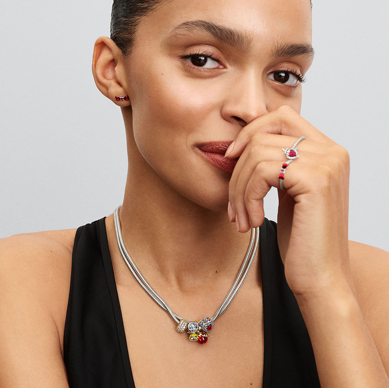 Model wearing necklace and rings 