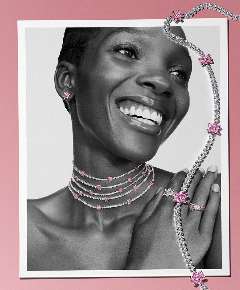 Model wearing Pandora butterfly charms on necklaces and bracelet