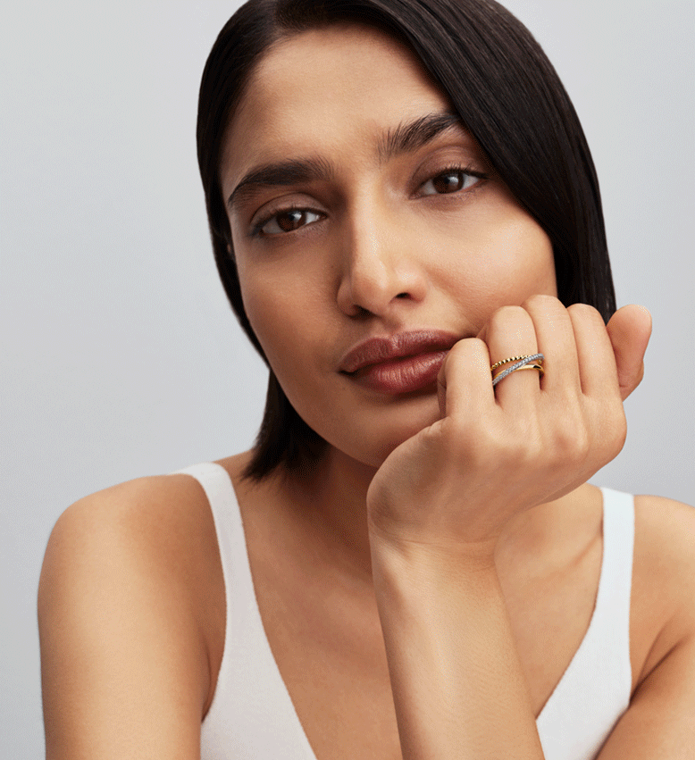 Model wears rings with contrasting metals