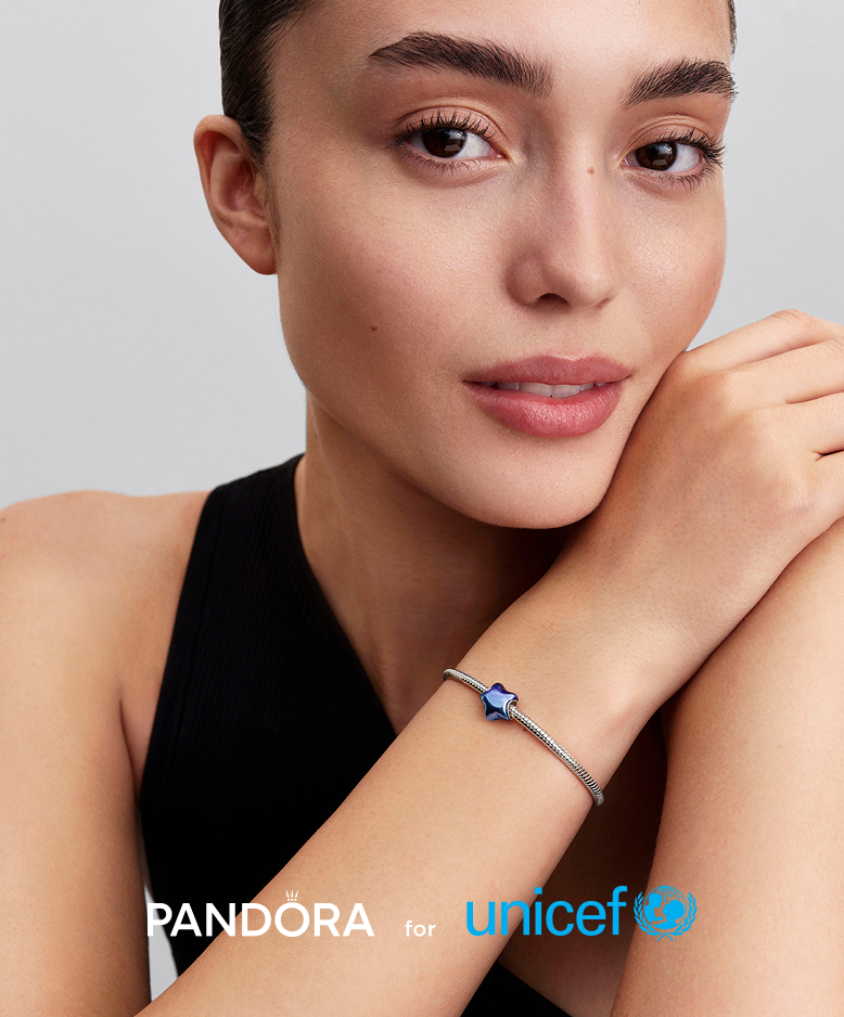 Model wears our new Pandora for UNICEF star charm, featuring a gradient enamel finish