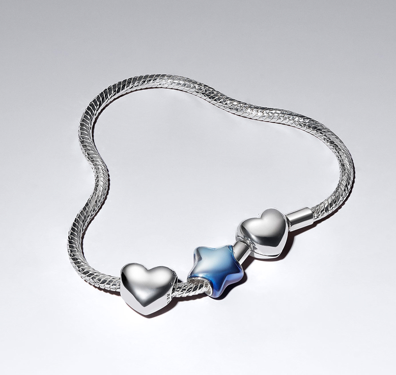 New Pandora for UNICEF star charm styled with our iconic Be Love hearts on a twisted snake chain bracelet