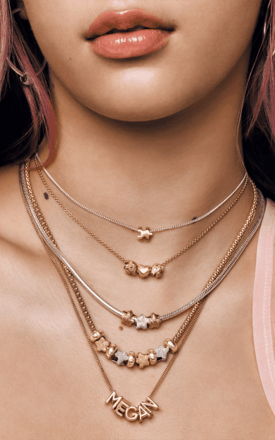 Megan layers our new 14k gold-plated puzzle piece with other Pandora Minis in mixed metals