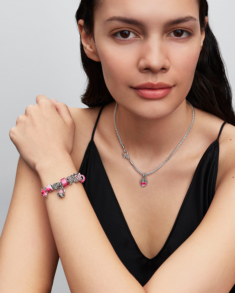 Model wearing Pandora charm bracelet