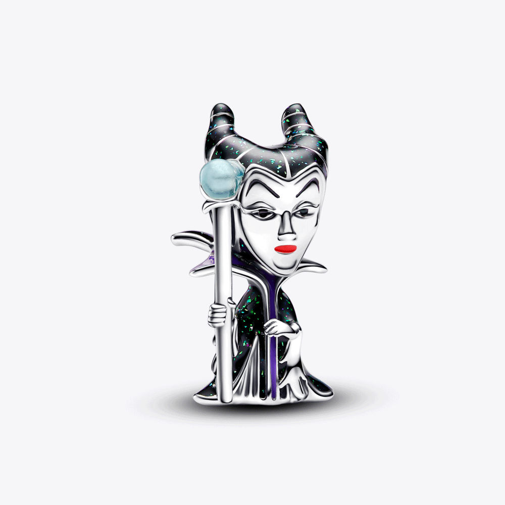A selection of stacked Disney Villain charms and rings on a white background