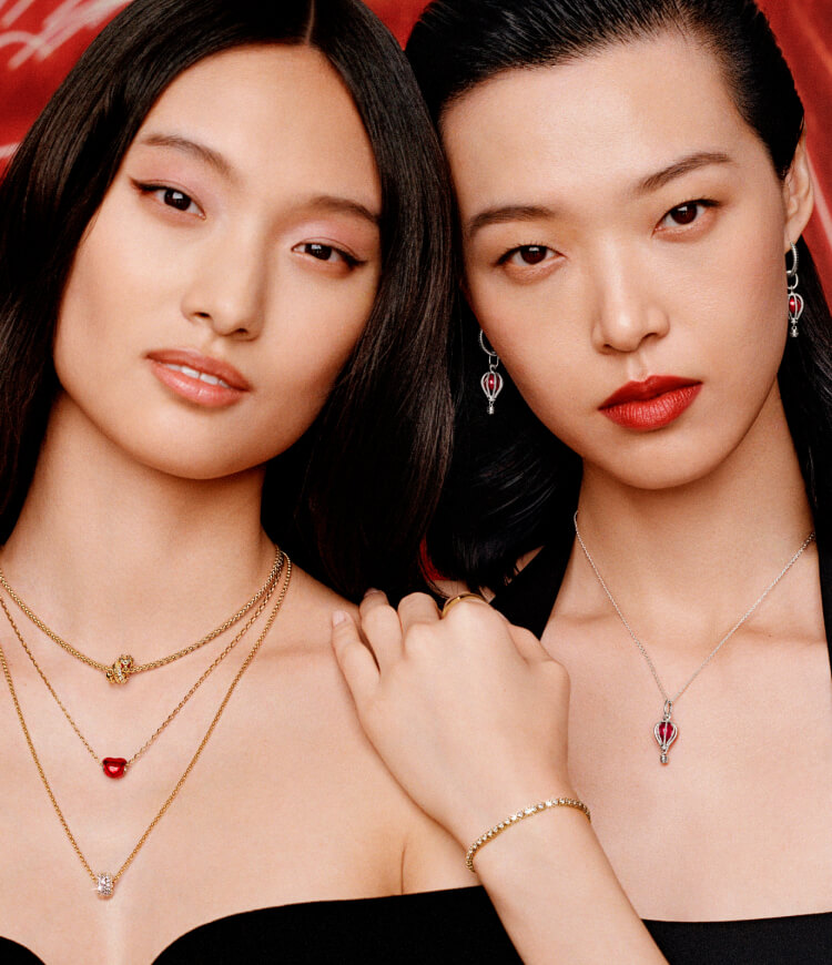 Two women wearing Pandora necklaces and bracelets