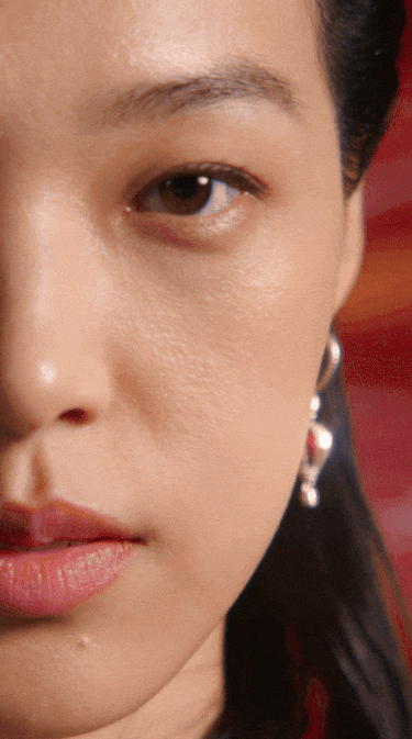 Model wears Pandora earrings with charms