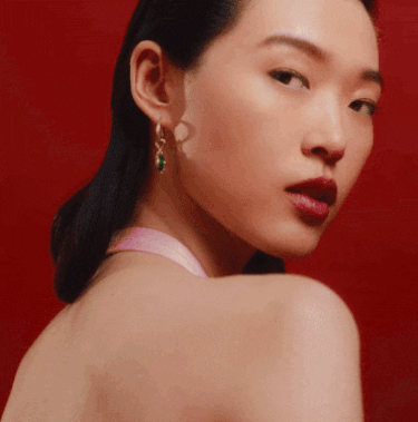 Model wearing Pandora earrings with snake charms