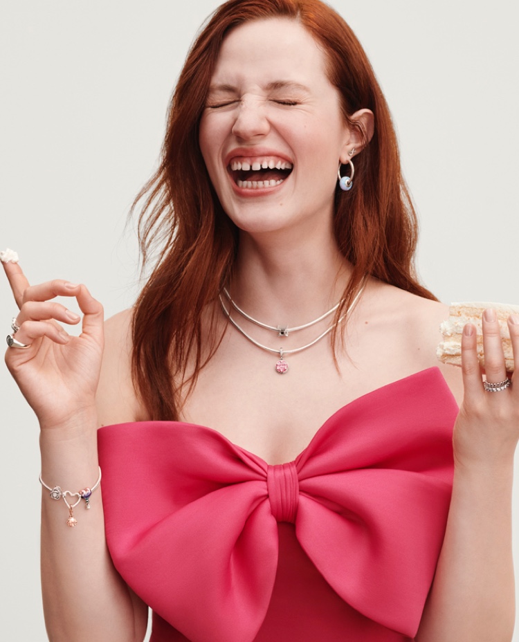 Woman wearing Pandora jewellery and holding cake